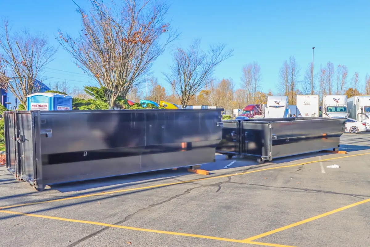 Professional dumpster rental service with roll-off container on residential driveway in Lower Paxton